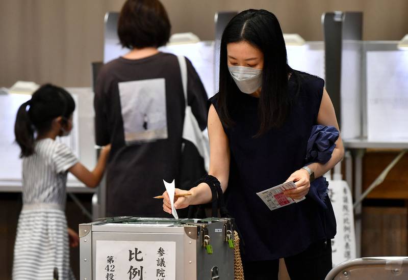 A voter casts her ballot in Japan's upper house election at a polling station in Tokyo on July 10. AFP