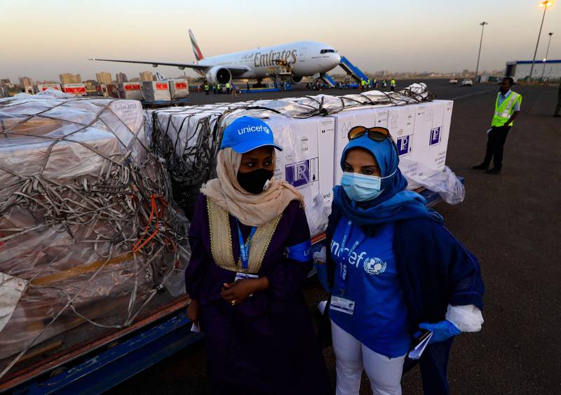 Workers from the UN children's fund supervise the arrival of the first batch of Oxford-AstraZeneca Covid-19 vaccine at Khartoum airport. AFP