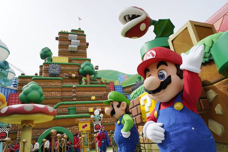 The Nintendo video game characters "Mario," right, and "Luigi" stand in the main plaza of the new Universal Studios Hollywood attraction Super Nintendo World during a preview day, Thursday, Feb.  16, 2023, in Universal City, Calif.  The attraction opens to the public Friday.  (AP Photo / Chris Pizzello)