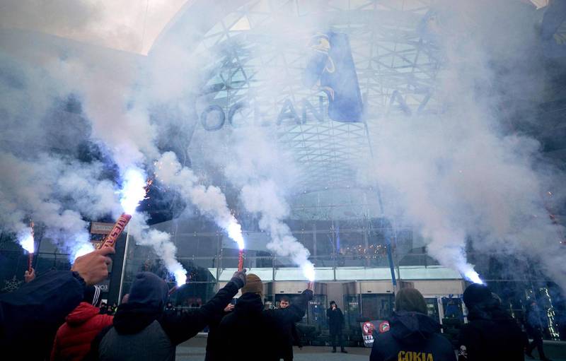 Ukrainian far-right group activists hold flares in Kiev as they block work at a huge shopping mall "Ocean Plaza" belonging to Russian business man and oligarch Boris Rotenberg, a figure close to President Vladimir Putin. AFP