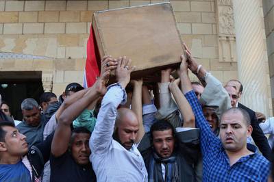 People carry the coffin of police captain Ahmed Fayez, who was killed in a gun battle which began Friday, in al-Wahat al-Bahriya area in Giza province, about 135 kilometres southwest of Cairo.  Alaa Elkassas / AP Photo