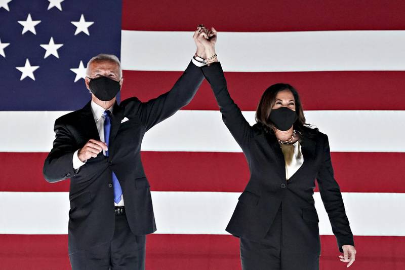 Former Vice President Joe Biden, Democratic presidential nominee, left, and Senator Kamala Harris, Democratic vice presidential nominee, wear protective masks while holding hands outside the Chase Center during the Democratic National Convention in Wilmington, Delaware, USA. Bloomberg