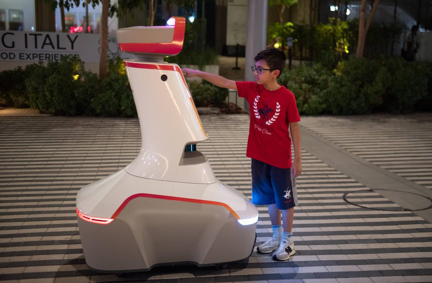 A visitors interacts with one of the security robots at Expo 2020 Dubai. Photo: Expo 2020 Dubai