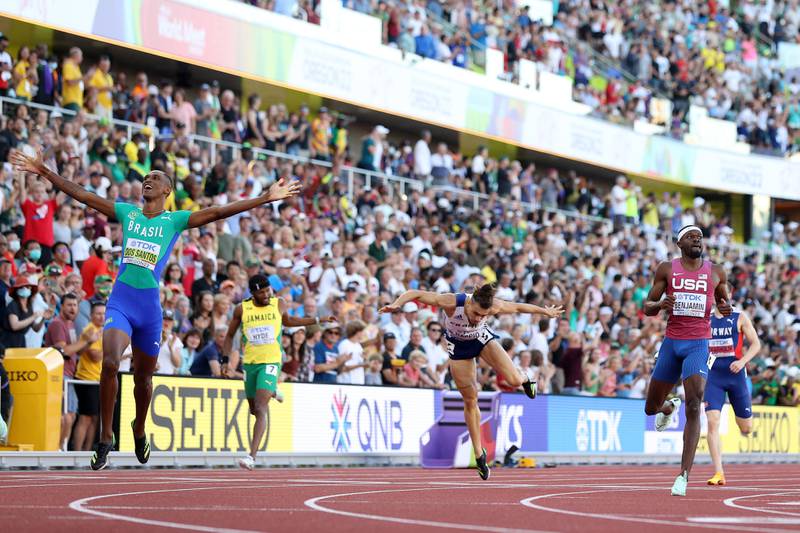 Alison dos Santos and Rai Benjamin cross the finish line in the men's 400m hurdles final. Getty
