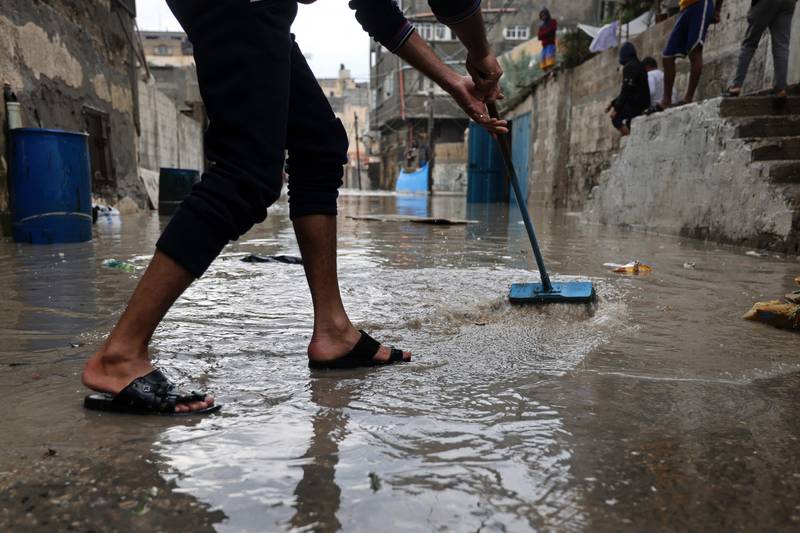 Clearing floodwater after heavy rain at Al Shatee refugee camp in Gaza City. AFP