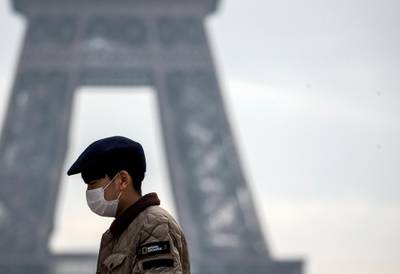 epa08163055 A tourist wears a face mask near the Eiffel Tower in Paris, France, 25 January 2020. Three cases of the Wuhan coronavirus have been identified in France, the Health Ministry announced on 24 January. Wuhan is the city at the center of the coronavirus outbreak which has caused 41 deaths and infected more than 1,287 people in China where authorities also confirmed that human-to-human transmission of the virus had taken place. The virus has so far spread to the USA, Thailand, South Korea, Japan, Singapore and Taiwan.  EPA/IAN LANGSDON