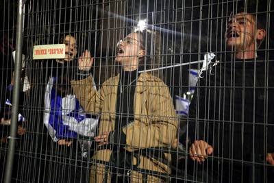 Demonstrators outside Mr Netanyahu's residence in Jerusalem. AFP