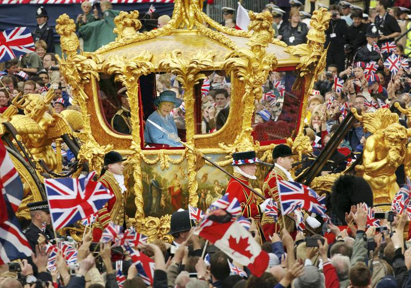 LONDON - JUNE 4:  Britain's Queen Elizabeth and Prince Philip ride in the Golden State Carriage at the head of a parade from Buckingham Palace to St Paul's Cathedral celebrating the Queen's Golden Jubilee June 4, 2002 along The Mall in London.  (Photo by Sion Touhig/Getty Images)