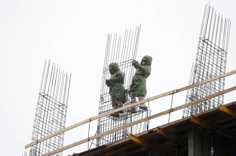Construction workers at a housing project in Moscow, Russia.  EPA