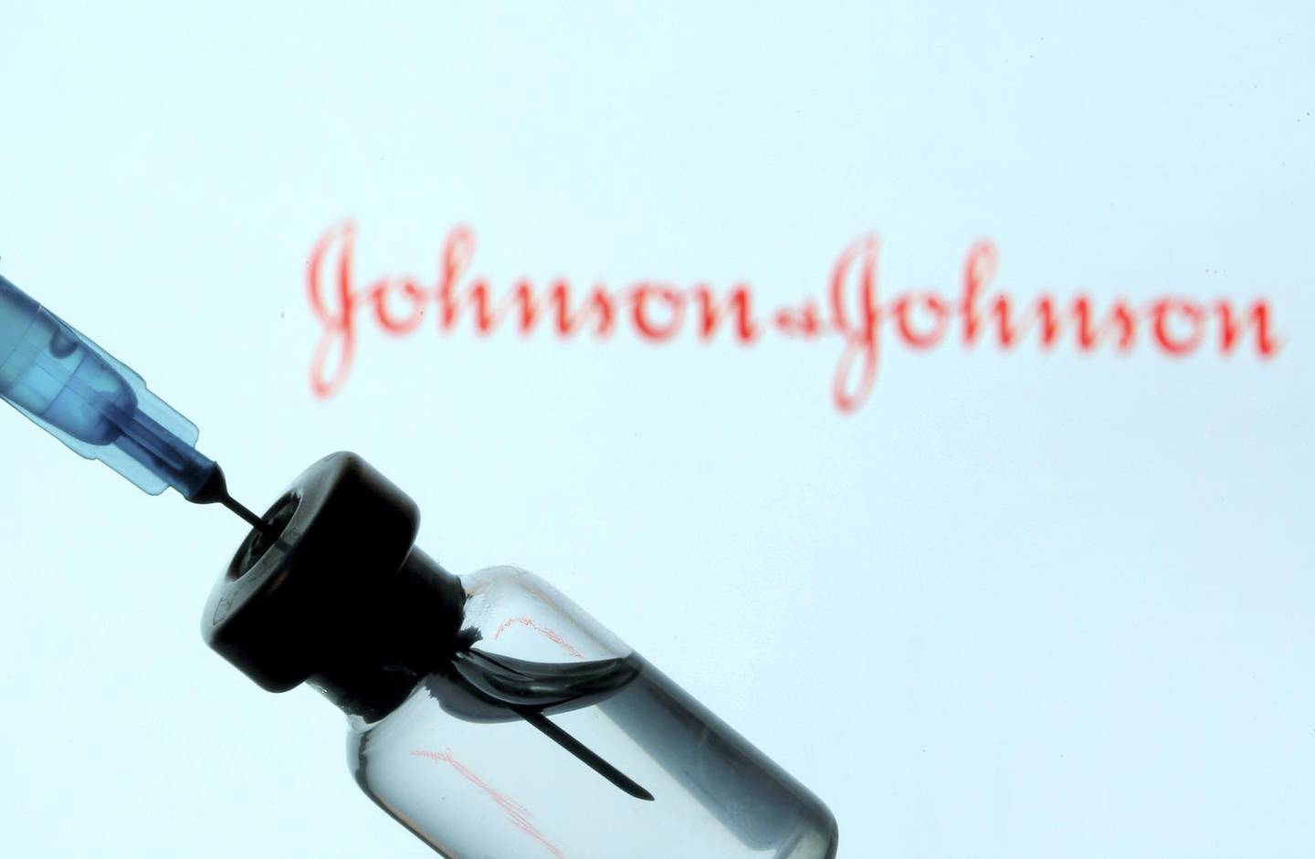 FILE PHOTO: A vial and sryinge are seen in front of a displayed Johnson&Johnson logo in this illustration taken January 11, 2021. REUTERS/Dado Ruvic/Illustration/File Photo