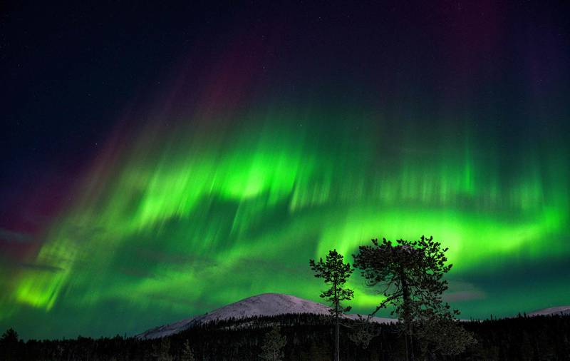 An aurora borealis, also known as Northern Lights, illuminates the night sky above the Kellostapuli Fell in Kolari, Finnish Lapland, early on January 15, 2022.  (Photo by Irene Stachon  /  Lehtikuva  /  AFP)  /  Finland OUT