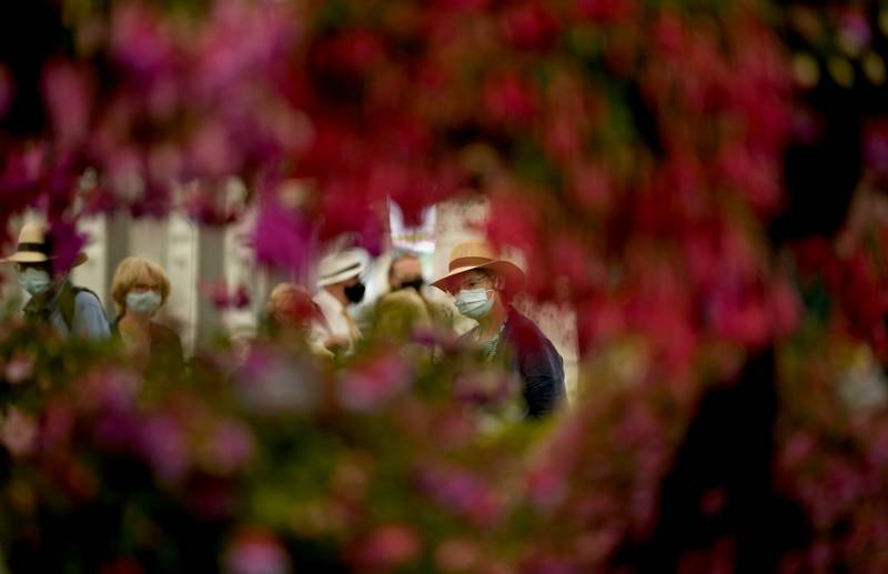 People wear face coverings inside the Floral Marquee during the press day for the RHS Hampton Court Palace Garden Festival in south-west London.