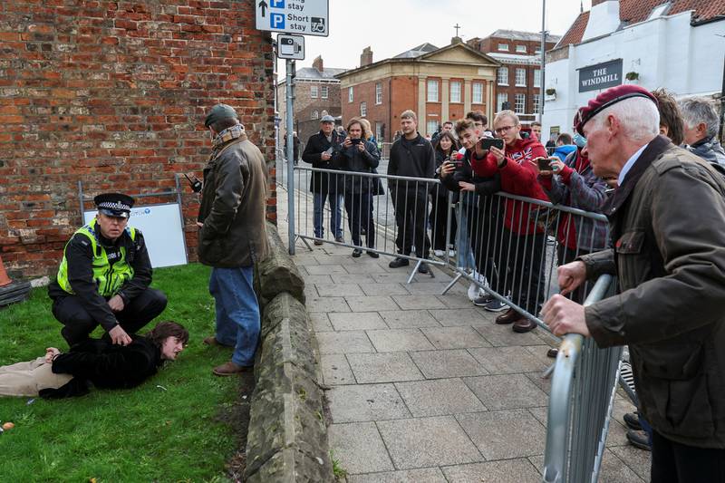 Police restrain a man who threw an egg at Britain's King  Charles III during his visit to York. Reuters