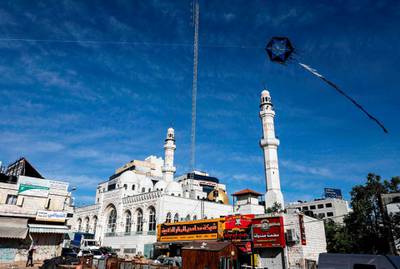 A kite is being flown near the Jamal Abdel Nasser Great Mosque in the centre of the occupied West Bank city of Ramallah. AFP