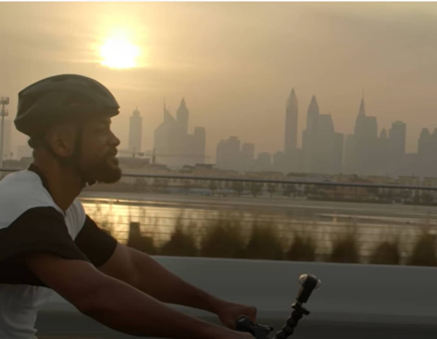 Will Smith is seen cycling with the Downtown Dubai skyline in the background in the first trailer for his new YouTube docuseries. Photo: YouTube