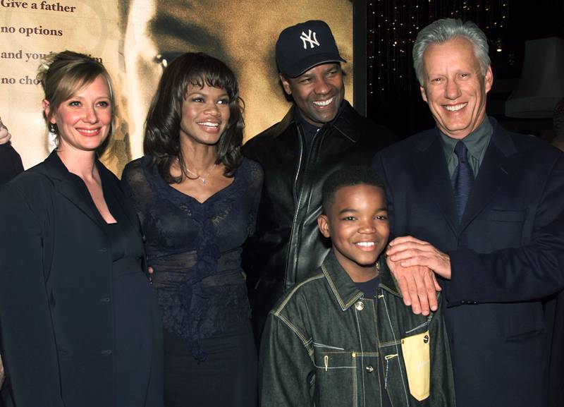 The cast of the new film 'John Q', from left, Anne Heche, Kimberly Elise, Denzel Washington, young Daniel Smith and James Woods, at the film's premiere in 2002 in Los Angeles. Reuters
