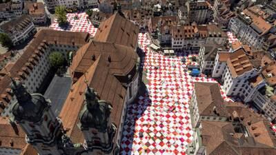 A giant picnic blanket covers streets and Klosterhof square during the Bignik art installation initiated by Swiss concept artists Frank and Patrik Riklin, in the old town of St. Gallen, Switzerland. Reuters