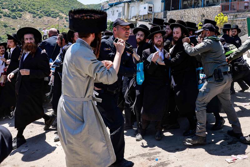 Ultra-Ortodox Jewish children scuffle with the police as they try to enter the grave site of Rabbi Shimon Bar Yochai in the northern Israeli village of Meron during the  holiday of Lag BaOmer that commemorates the Jewish scholar's death.  AFP