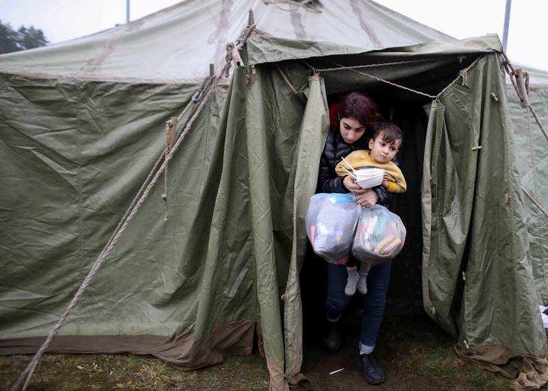 A migrant woman and child at their a tent in the Grodno region. Reuters