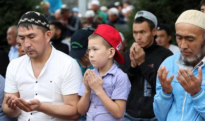 Kyrgyz people pray during at the central square in Bishkek, Kyrgyzstan.  EPA