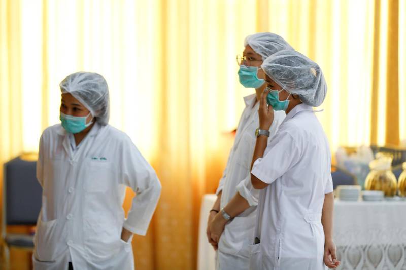 Hospital workers watch a press conference at their hospital where rescued boys are tended to, in Chiang Rai province, northern Thailand, Tuesday, July 10, 2018. A Thai public health official said Tuesday the eight boys rescued from a flooded cave in northern Thailand are in "high spirits" and have strong immune systems because they are soccer players. (AP Photo/Vincent Thian)