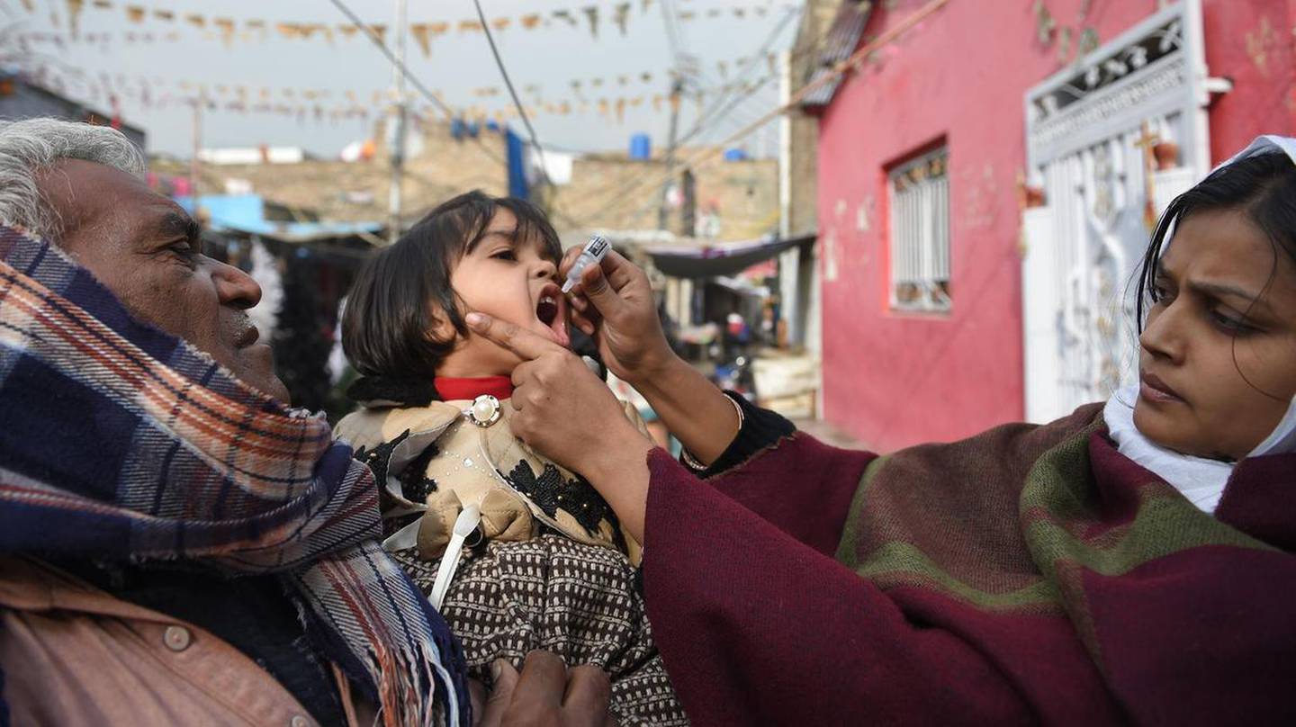 A Pakistani health worker administers polio vaccine drops to a child during a polio vaccination campaign in Islamabad in December 2018. The country is one of a handful where cases are still recorded. AFP