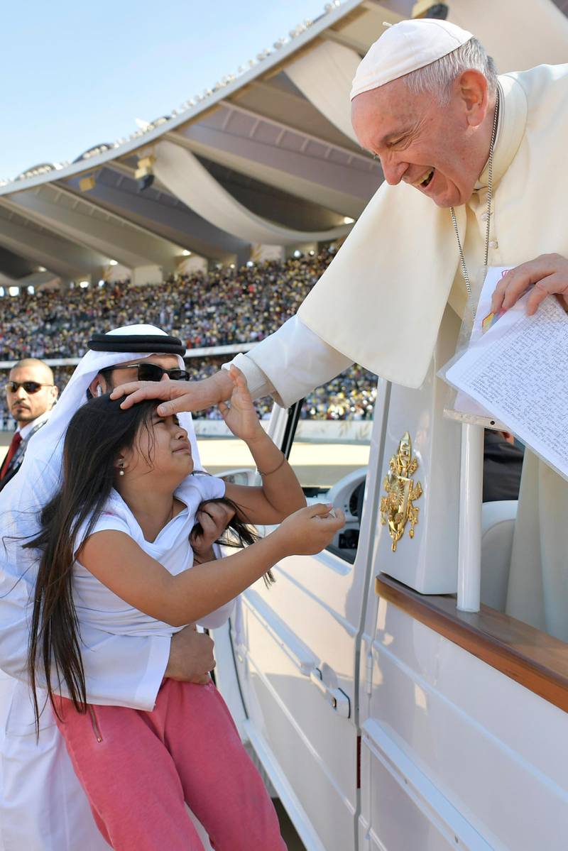 Pope Francis blesses a child before celebrating a mass at Zayed Sports City Stadium in Abu Dhabi, United Arab Emirates, February 5, 2019. Vatican Media/­Handout via REUTERS  ATTENTION EDITORS - THIS IMAGE WAS PROVIDED BY A THIRD PARTY.
