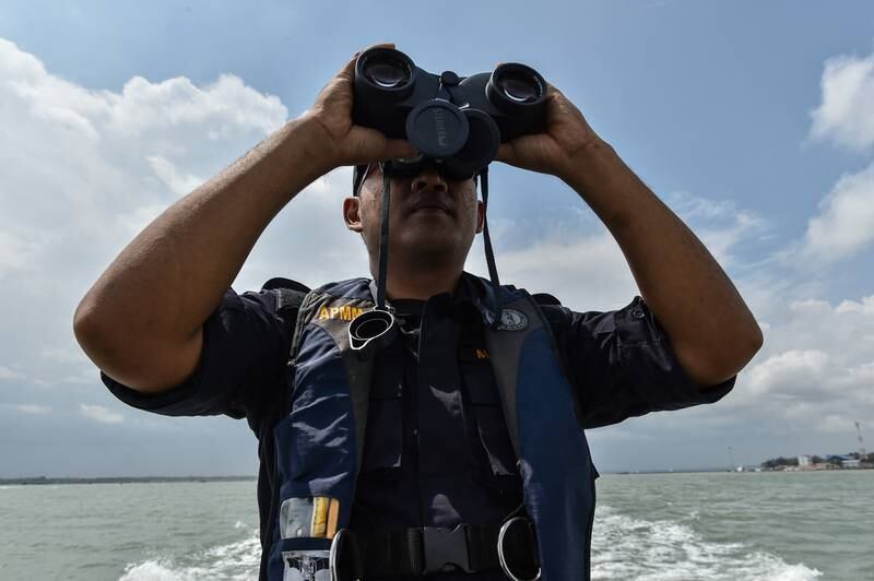 A member of the Malaysian Maritime Enforcement Agency. The agency is searching for four European divers, including two teenagers, who disappeared during training. AFP
