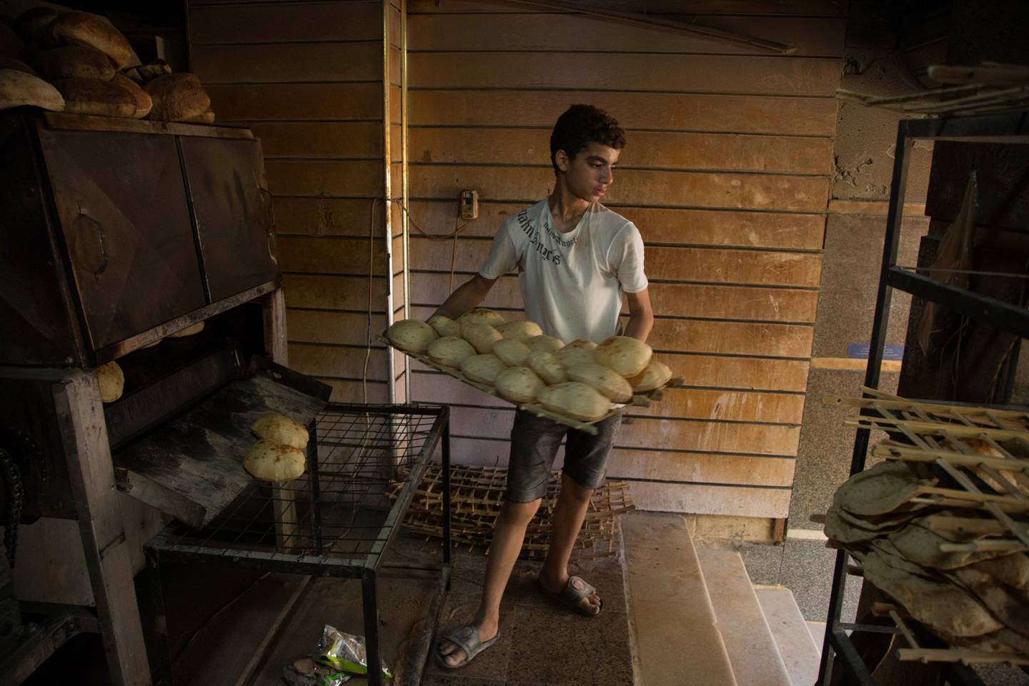 A bakery worker in Cairo, where many residents are feeling the pinch. Bloomberg.
