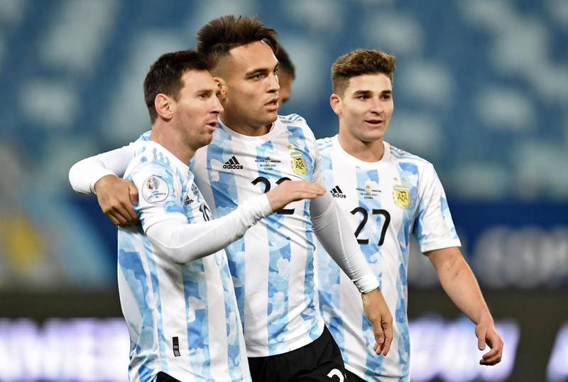 Argentina's Lautaro Martinez celebrates with Lionel Messi after scoring against Bolivia. AFP