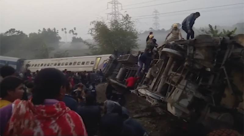 This image from video shows rescuers looking inside derailed coaches after a passenger train derailed in Jalpaiguri, West Bengal state. AP