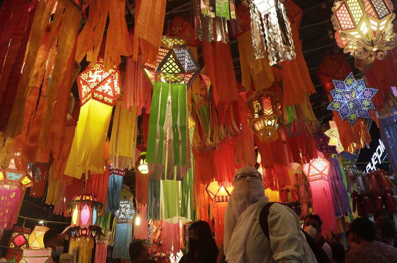 A woman looks at lanterns displayed in roadside stalls ahead of the Diwali festival in Mumbai. The global chip shortage has impacted sales of electronics and automobiles during the festival season. AP 