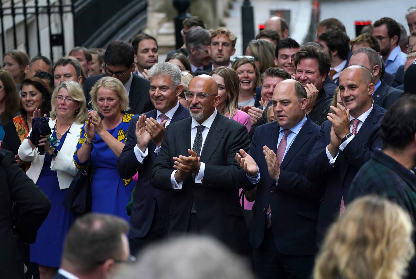 Secretary of State for Northern Ireland Brandon Lewis, centre left, Nadhim Zahawi, centre, and Defence Secretary Ben Wallace, centre right, clap after a speech by the new Prime Minister Liz Truss.