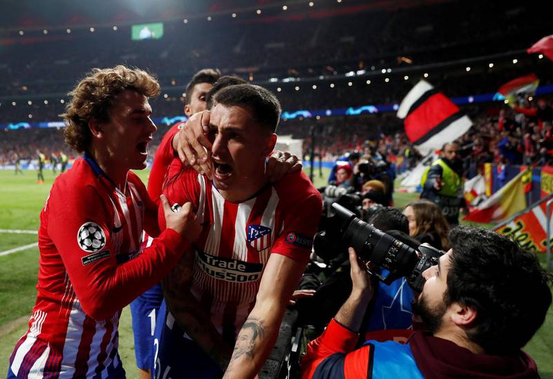 Jose Gimenez celebrates with teammates after scoring the opening goal. Reuters