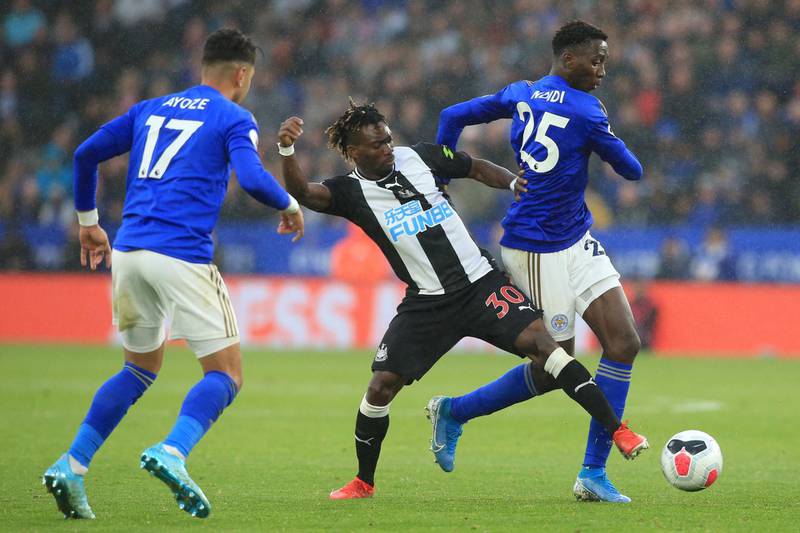 Newcastle United's Ghanaian midfielder Christian Atsu (C) vies with Leicester City's Spanish striker Ayoze Perez (L) and Leicester City's Nigerian midfielder Wilfred Ndidi (R) during the English Premier League football match between Leicester City and Newcastle United at King Power Stadium in Leicester, central England on September 29, 2019. - Leicester won the game 5-0. (Photo by Lindsey Parnaby / AFP) / RESTRICTED TO EDITORIAL USE. No use with unauthorized audio, video, data, fixture lists, club/league logos or 'live' services. Online in-match use limited to 120 images. An additional 40 images may be used in extra time. No video emulation. Social media in-match use limited to 120 images. An additional 40 images may be used in extra time. No use in betting publications, games or single club/league/player publications. / 