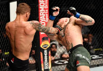 ABU DHABI, UNITED ARAB EMIRATES - JANUARY 23: (L-R) Dustin Poirier punches Conor McGregor of Ireland in a lightweight fight during the UFC 257 event inside Etihad Arena on UFC Fight Island on January 23, 2021 in Abu Dhabi, United Arab Emirates. (Photo by Jeff Bottari/Zuffa LLC)