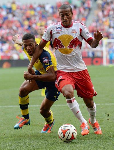 New York Red Bulls player Roy Miller, right, fights for the ball against Arsenal's Isaac Hayden during their friendly on Saturday. Don Emmert / AFP