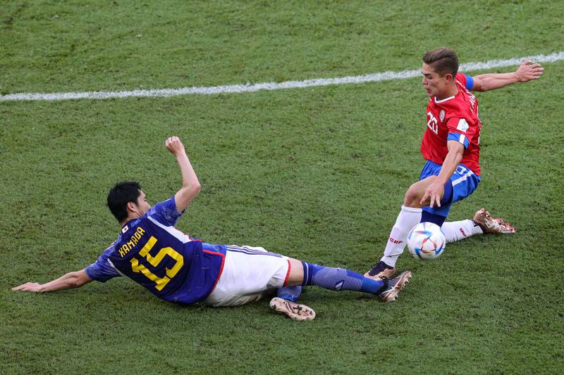 Japan's Daichi Kamada, left, and Costa Rica's Brandon Aguilera fight for the ball. AFP