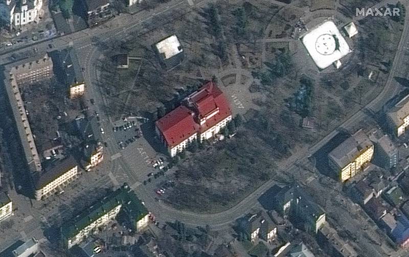 A satellite image of the theatre before the bombing, with the word 'children' written in Russian in large white letters on the pavement in front of and behind the building. Reuters