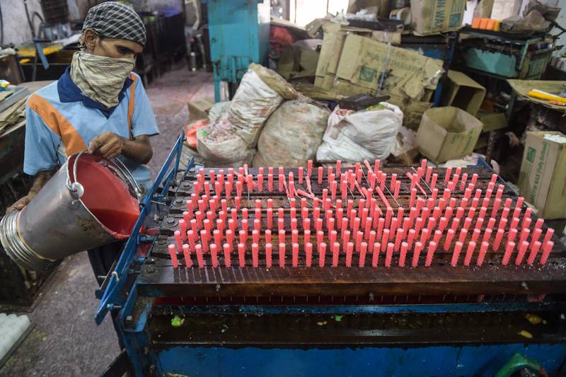 A worker makes candles in Ahmedabad. AFP
