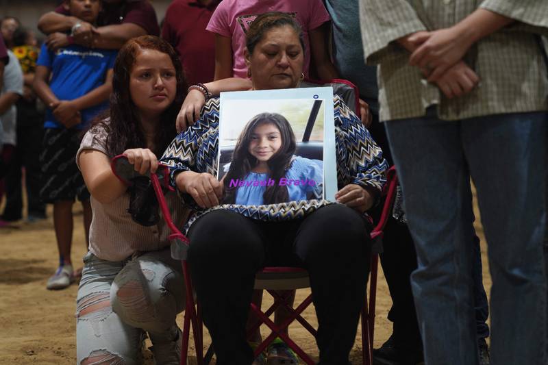 A woman holds a photo of Nevaeh Bravo, who was killed in the mass shooting, during a vigil for the victims of the massacre in Uvalde, Texas. AFP