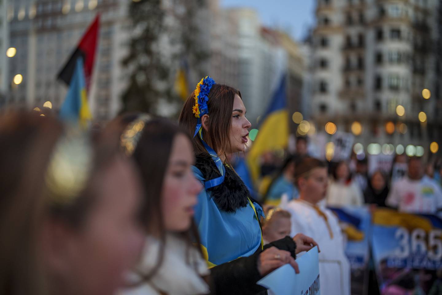 Ukrainian people take part in a protest marking one year since Russia's invasion of Ukraine in Madrid. AP 