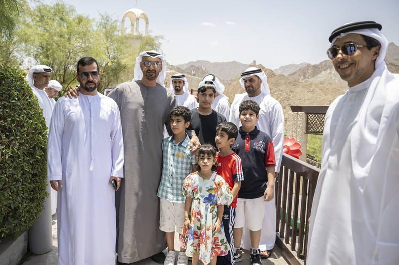 The President, Sheikh Mohamed, stands for a photograph with an Emirati family during a tour of the Northern Emirates. Seen with Sheikh Mansour bin Zayed, Deputy Prime Minister and Minister of Presidential Affairs. Hamad Al Kaabi / Ministry of Presidential Affairs 