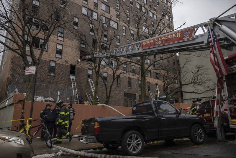 Emergency personnel at the scene of the fatal fire in the Bronx.  AP