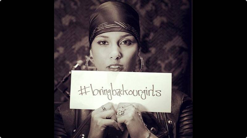 Alicia Keys holds up a #BringBackOurGirls sign. Courtesy Alicia Keys