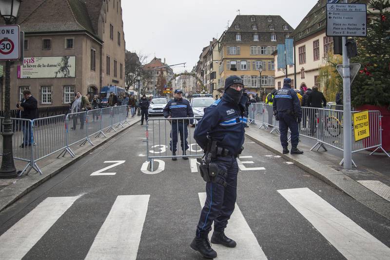 STRASBOURG, FRANCE - DECEMBER 12: Police officers stand near the Christmas market where the day before a man shot 14 people, killing at least three, on December 12, 2018 in Strasbourg, France. Police have identified the man as Cherif Chekatt, a French citizen on a police terror watch-list. Chekatt exchanged gunfire with soldiers after the attack, is reportedly injured and is still on the loose. (Photo by Thomas Lohnes/Getty Images)