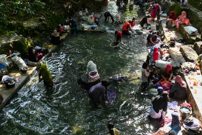 People wash clothes in a public pool of spring water in Japakeh, Indonesia, on World Water Day. AFP