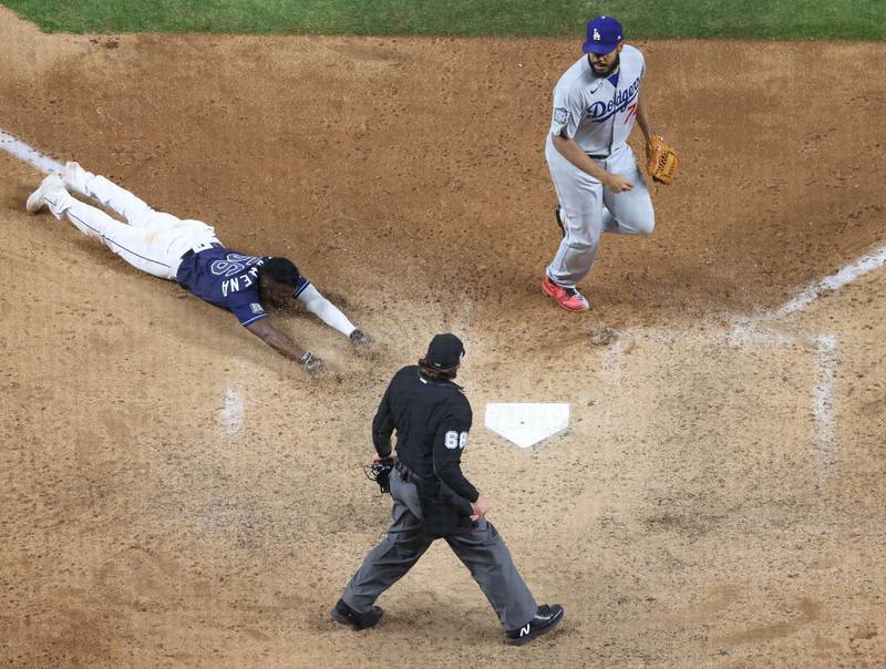 Randy Arozarena of the Tampa Bay Rays slides into home plate  to score the game-winning run and give his team the 8-7 victory against the Los Angeles Dodgers in Game 4 of the MLB World Series at Globe Life Field in Arlington, Texas on Saturday, October 24. AFP