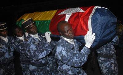 Togolese gendarmes carry a coffin wrapped in the national flag of one of the victims of an on the Togolese national football team on January 8, 2010.