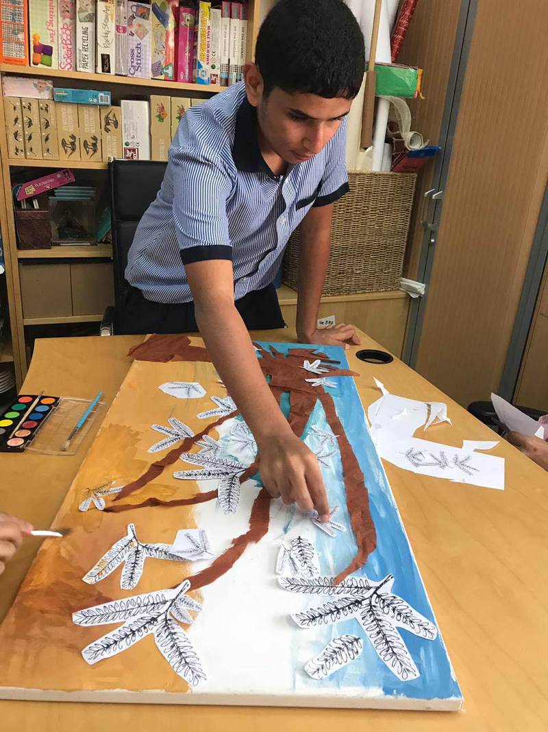 Children from Senses painting a Ghaf tree to be made into a carpet for Dubai Design Week. Courtesy Hands